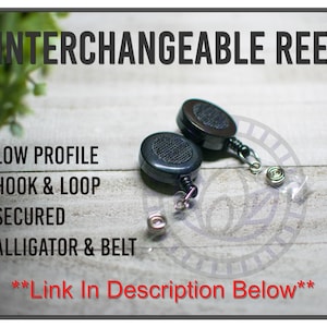 May include: Two black interchangeable reels with a low profile design, hook and loop, secured with an alligator and belt clip. The image includes the text "INTERCHANGEABLE REEL" and other descriptive text.