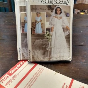 May include: Vintage Simplicity sewing pattern number 7259 for a wedding dress. The pattern is for misses sizes 6-16. The pattern features a white wedding dress with a lace bodice and a full skirt. The model is wearing a veil and holding a bouquet of flowers.