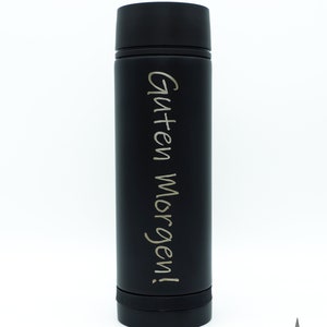May include: A black stainless steel water bottle with the text "Guten Morgen!" engraved in silver lettering.