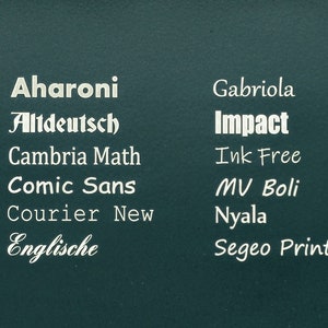 May include: A teal green background with a list of different font names in white text. The font names are: Aharoni, Altdeutsch, Cambria Math, Comic Sans, Courier New, Englische, Gabriola, Impact, Ink Free, MV Boli, Nyala, and Segeo Print.