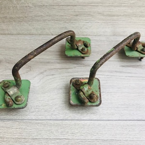 May include: Three vintage metal door handles with green painted bases and rusty metal hardware.