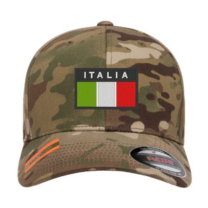 May include: A camouflage baseball cap with an embroidered Italian flag patch and the word "ITALIA" above it. The cap has a black Flexfit logo on the back.
