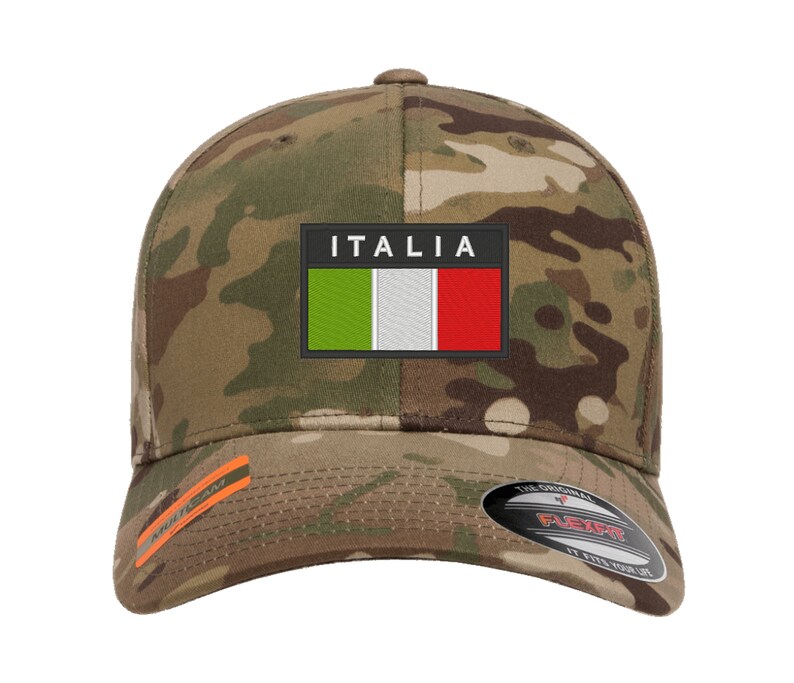 May include: A camouflage baseball cap with an embroidered Italian flag patch and the word "ITALIA" above it. The cap has a black Flexfit logo on the back.