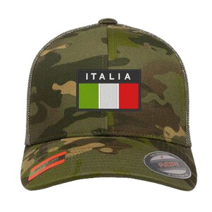May include: A camouflage trucker hat with a black patch featuring the Italian flag and the word "ITALIA" in white text.