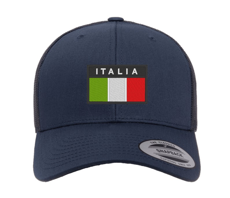 May include: A navy blue trucker hat with a black mesh back. The hat features a white patch with the Italian flag and the word "ITALIA" in white letters.