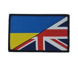 May include: A patch featuring the Ukrainian flag and the British flag, both flags are split diagonally with the Ukrainian flag on top and the British flag on the bottom.