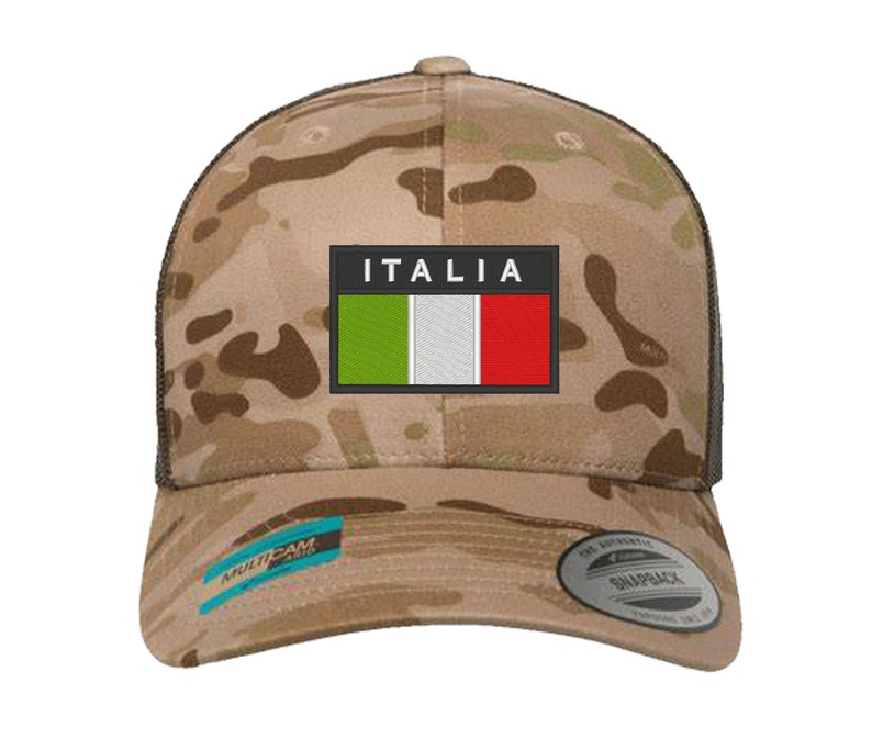 May include: A camouflage trucker hat with a black mesh back. The front of the hat features a patch with the Italian flag and the word "ITALIA" in white letters.