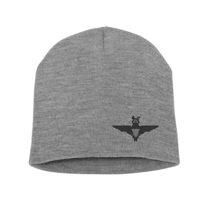 May include: Grey beanie with a black embroidered parachute regiment insignia.