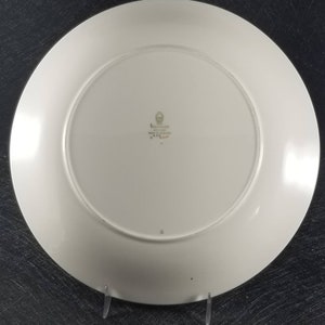 May include: White ceramic dinner plate with a green and gold Wedgwood logo and the text "Made in England" and "Yare" on the bottom.