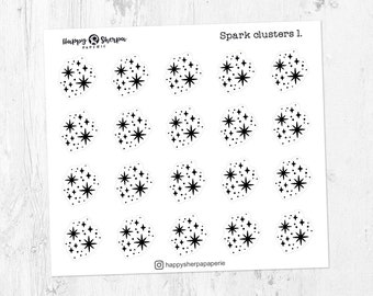 May include: A sheet of white stickers featuring black starburst clusters. The text "Spark clusters 1." is at the top right. The Happy Sherpa Paperie logo and Instagram handle are also visible.