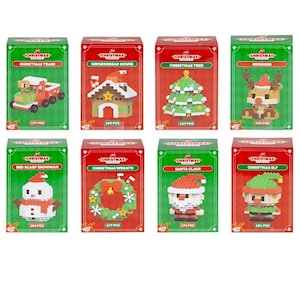 May include: Eight boxed Christmas-themed building block sets. Each box features a different design, including a train, gingerbread house, Christmas tree, reindeer, snowman, wreath, Santa Claus, and elf. The boxes are red and green.