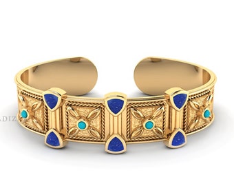 May include: A gold cuff bracelet with a geometric design featuring blue and turquoise gemstones.