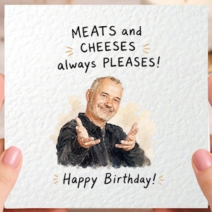 May include: A square greeting card with a textured white surface featuring a watercolour illustration of a man with his hands outstretched. The text reads MEATS and CHEESES always PLEASES! and Happy Birthday! in black, hand-lettered style font.