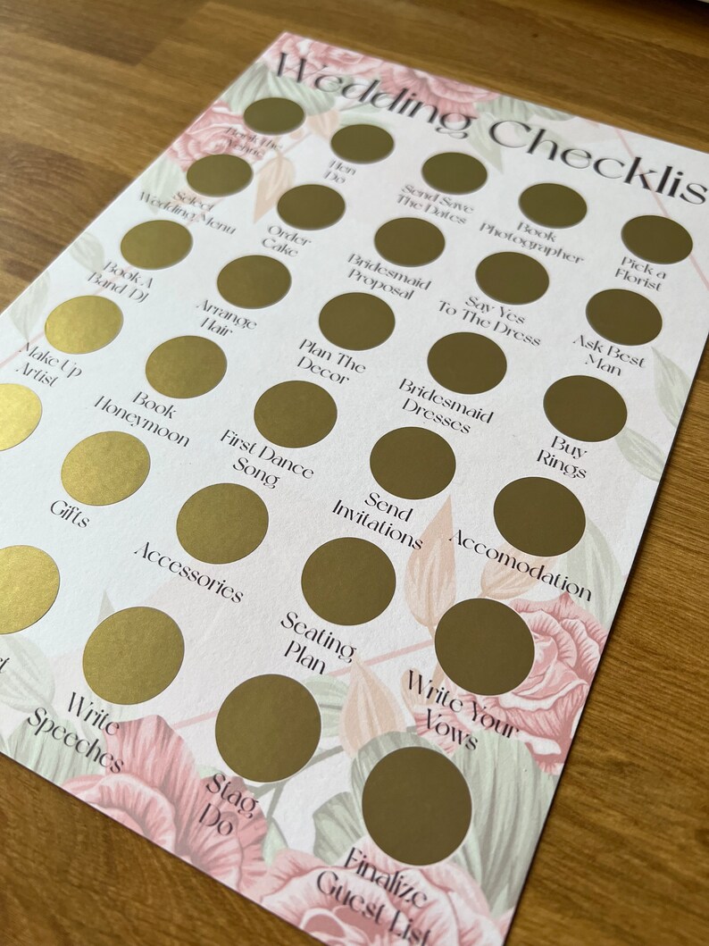 May include: A wedding checklist with gold circles to mark off tasks. The checklist includes items like "Book a Band/DJ", "Order Cake", "Plan the Decor", "Send Invitations", "Write Your Vows", and "Finalize Guest List".