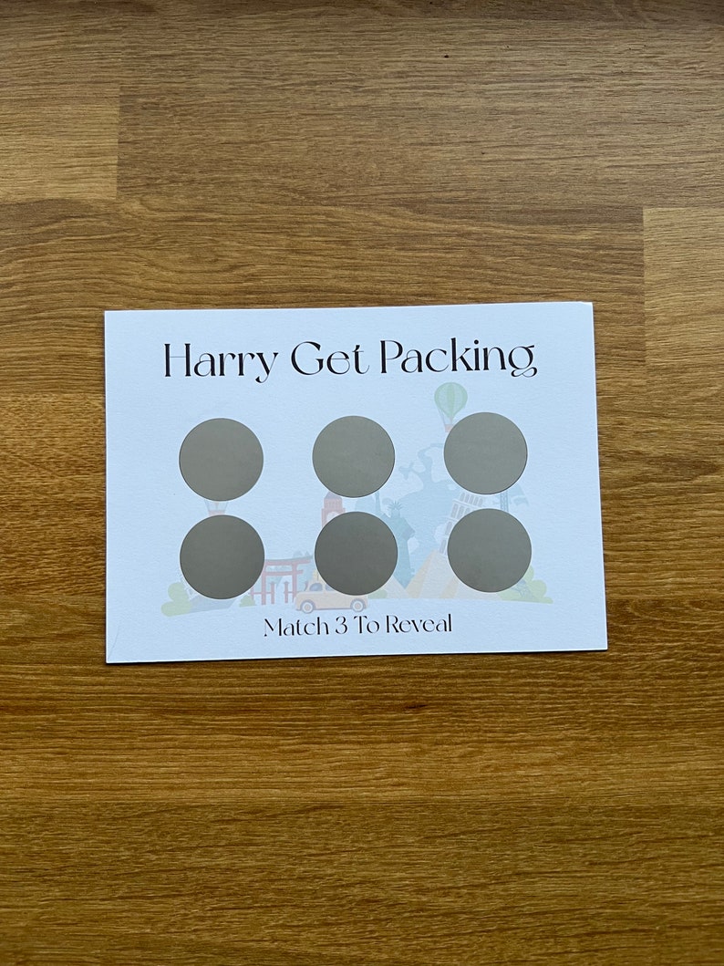 May include: A white card with the text "Harry Get Packing" and a colorful illustration of a travel scene. There are six gray circles on the card with the text "Match 3 To Reveal" at the bottom.