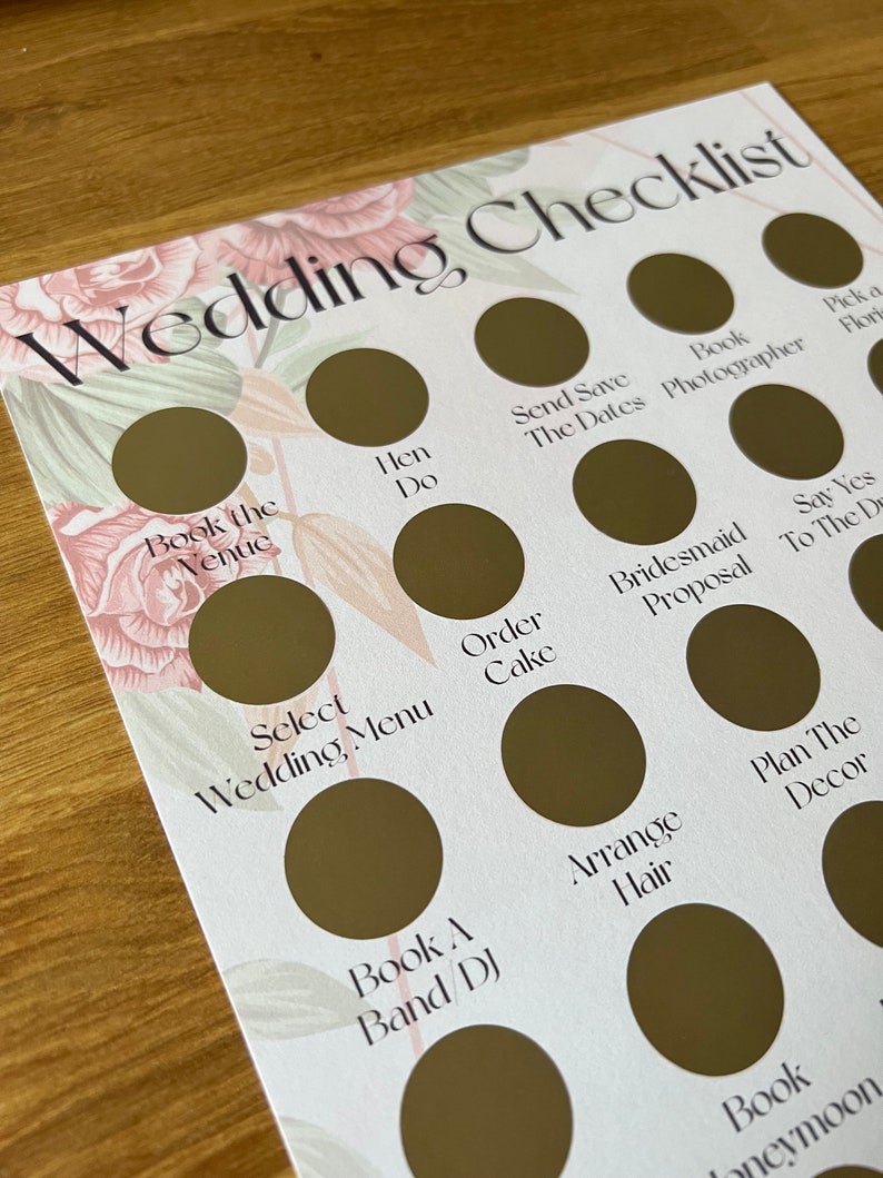 May include: A wedding checklist with a floral design. The checklist includes tasks such as booking the venue, ordering the cake, and planning the decor.