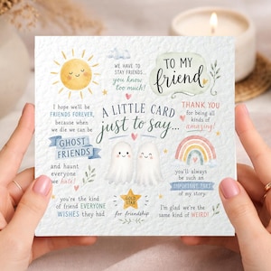 May include: A square greeting card featuring two white ghosts in the centre with the text A LITTLE CARD JUST TO SAY... TO MY FRIEND. The card includes illustrations of a yellow sun, a rainbow, and stars, with phrases about friendship and ghost friends.