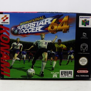 May include: A Nintendo 64 game cartridge box for International Superstar Soccer 64. The box is red, black, and white with a picture of football players on a green pitch. The game is a Major A Konami Sports Series game.
