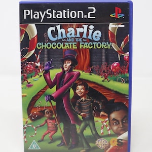 May include: PlayStation 2 video game case featuring a colorful illustration of Willy Wonka and Charlie Bucket from the movie "Charlie and the Chocolate Factory". The game is rated U for all ages.