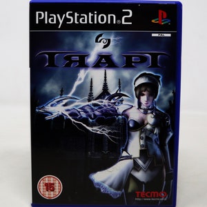 May include: PlayStation 2 game case with a blue background and a white and black image of a woman in a white dress with a black and white design. The game title is "TRAP" in a stylized font. The game is rated 15.