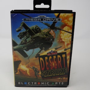May include: A Sega Mega Drive game cartridge for Desert Strike: Return to the Gulf, featuring a green helicopter against a desert background. The game is published by Electronic Arts.