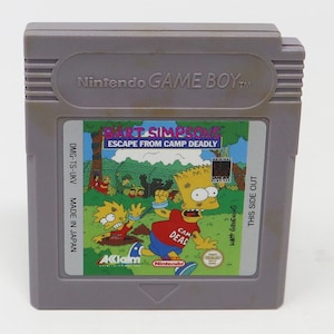 May include: A gray Game Boy cartridge with a green label featuring Bart Simpson from the cartoon series The Simpsons. The label reads "Bart Simpsons Escape From Camp Deadly" and features a cartoon image of Bart Simpson running with a chain around his ankle. The label also includes the text "Matt Groening" and "This Side Out".