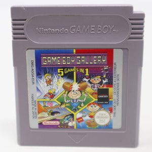 以下が含まれることがあります： グレーのゲームボーイカートリッジで、カラフルなラベルには「ゲームボーイギャラリー 5ゲームイン1」と書いてあります。ラベルには、漫画のキャラクターとさまざまなゲームシーンが描かれています。カートリッジは日本で製造されています。