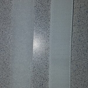 May include: Close-up of two strips of hook and loop fastener. The left strip is labeled "LOOP (Soft)" and the right strip is labeled "HOOK (Hard)".