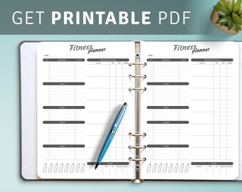 May include: An open ring-bound fitness planner with white pages featuring black text and grids for tracking meals, resistance training, and cardio. The text Fitness planner is printed at the top of each page. A blue ballpoint pen rests on the left page.