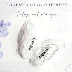 May include: A white embroidered butterfly applique featuring the names Grandpa and Grandma in black script. The butterfly is centered on a white background with the text OF THOSE WHO ARE FOREVER IN OUR HEARTS and Today and always.