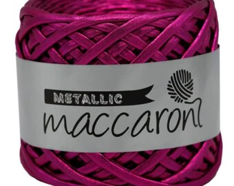 Può includere: Un rocchetto di filato macaron rosa metallizzato. Il filato è intrecciato a trama a cesto. L'etichetta riporta "Metallic maccaron".
