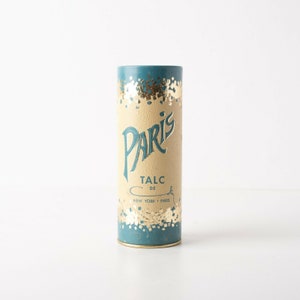 May include: A vintage blue and gold cylindrical container with the text "Paris Talc de New York - Paris" on the label.
