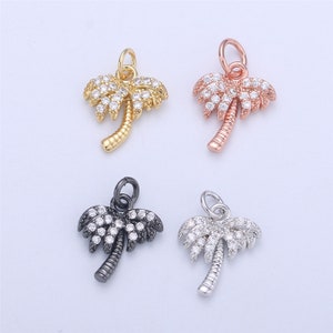 May include: Four palm tree charms with clear crystal accents. The charms are in gold, rose gold, silver, and black.