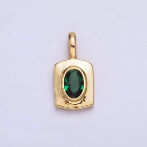 May include: A gold pendant with a green oval-shaped gemstone set in a square frame.