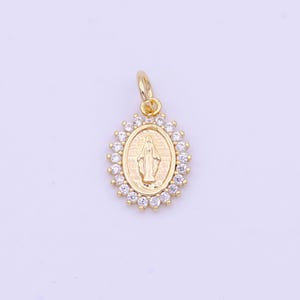 May include: Gold-toned pendant featuring a depiction of the Virgin Mary within an oval frame surrounded by clear cubic zirconia stones.