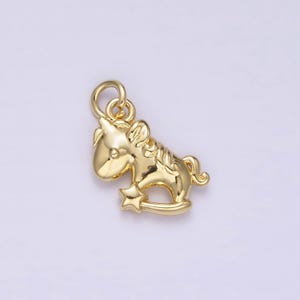 May include: Gold-toned metal charm shaped like a unicorn with a star on its hoof.