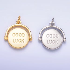 May include: Two gold and silver spinning charms with the words "Good Luck" engraved on them.