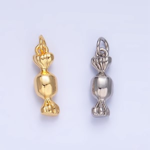 May include: Two candy charm pendants, one gold and one silver, in the shape of a wrapped candy.