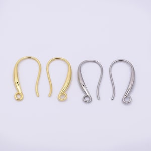 May include: Four earring hooks in gold and silver tones. The hooks are curved with a loop at the bottom for attaching earrings. The gold hooks are on the left, and the silver hooks are on the right.