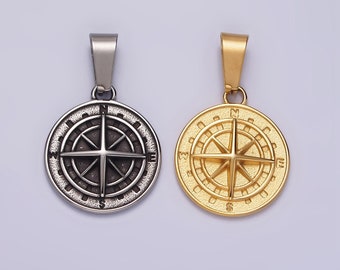 May include: Two compass pendants, one silver and one gold, with a detailed compass design featuring a star in the center and the letters N, S, E, and W around the edge.