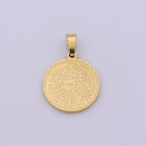 May include: Gold-toned metal pendant with a circular design featuring the words "Hail Mary, full of grace, the Lord is with thee. Blessed art thou among women, and blessed is the fruit of thy womb, Jesus. Holy Mary, Mother of God, pray for us sinners, now and at the hour of our death. Amen."