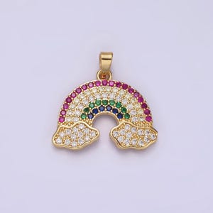 May include: A gold-tone rainbow pendant with clear and colorful cubic zirconia stones. The rainbow is set against a backdrop of two clouds, also adorned with clear cubic zirconia stones.