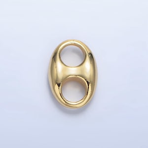 May include: Gold-toned metal connector with two oval-shaped loops. The connector is smooth and shiny.