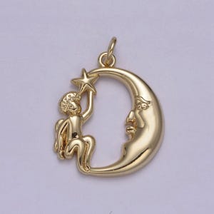 May include: A gold-toned pendant charm featuring a cherub holding a star, sitting on a crescent moon with a face.