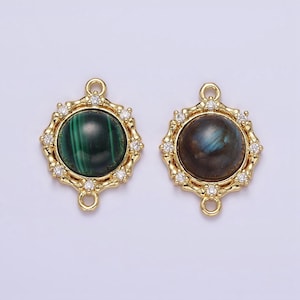 May include: Two gold-tone pendant charms with a round, cabochon gemstone set in a decorative frame. The charms have a loop on each side for attaching to a necklace or bracelet. One charm features a green malachite stone, and the other features a dark gray labradorite stone.