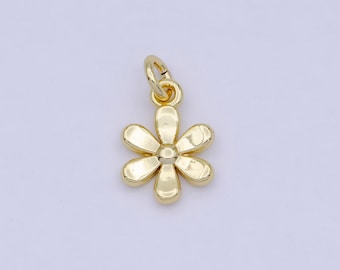 May include: A gold-colored flower charm with a loop for attaching to a necklace or bracelet.