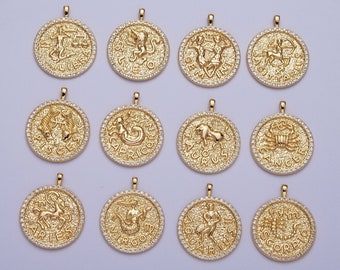 May include: Twelve gold zodiac pendants with clear rhinestone accents. Each pendant features a different zodiac sign with its corresponding symbol and name.