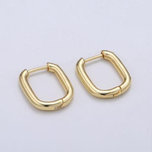 May include: A pair of gold-toned hoop earrings with a rectangular shape.