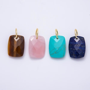 May include: Four rectangular pendants with faceted surfaces and gold-toned metal bails. The stones include brown tiger's eye, translucent light pink quartz, bright turquoise with natural veining, and deep blue lapis lazuli with gold flecks.