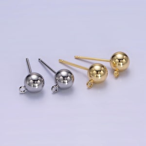 May include: Four earring findings, two gold and two silver, with a round ball at the end of each post.